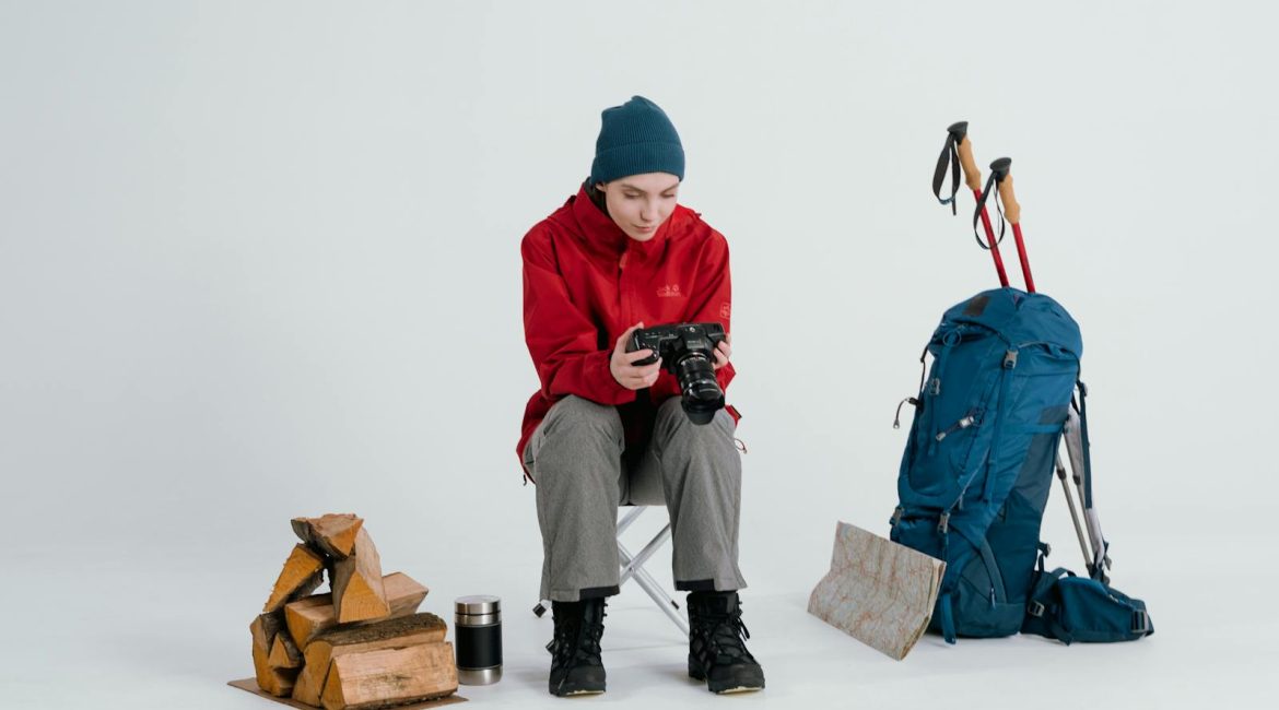 Woman in winter gear with backpack and map preparing for a hiking adventure